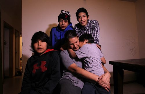 Photos for  Mary Agnes feature piece on CFS, Nelson House First Nation. Shirley Swanson, who at one time had her kids apprehended is now a inspiration to other mothers in the community after getting her life back on track and her kids back.  Photos of her with 4 of her 5 boys in their home in Nelson House. See story on how Nelson House Family and Community Wellness Centre is helping the community.   Names: Shirley Swanson with her youngest son Zacheus (grey), Silus (black), Nathan (blue) and Angus (plaid),  Phillip not in photo.   Nov 04, 2015 Ruth Bonneville / Winnipeg Free Press