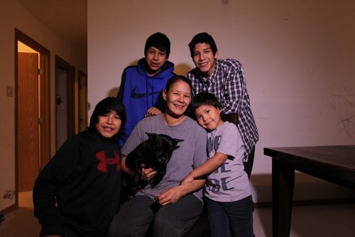 Photos for  Mary Agnes feature piece on CFS, Nelson House First Nation. Shirley Swanson, who at one time had her kids apprehended is now a inspiration to other mothers in the community after getting her life back on track and her kids back.  Photos of her with 4 of her 5 boys in their home in Nelson House. See story on how Nelson House Family and Community Wellness Centre is helping the community.   Names: Shirley Swanson with her youngest son Zacheus (grey), Silus (black), Nathan (blue) and Angus (plaid),  Phillip not in photo.   Nov 04, 2015 Ruth Bonneville / Winnipeg Free Press