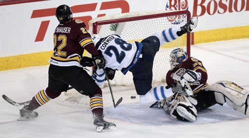Winnipeg Moose #28 Patrice Cormier flies past Wolves defenceman #22 Konrad Abeltshauser and netminder #30 Pheonix Copley and through the crease as he scores the tying goal against the Chicago Wolves Thursday evening. See story. November 12, 2015 - (Phil Hossack / Winnipeg Free Press)