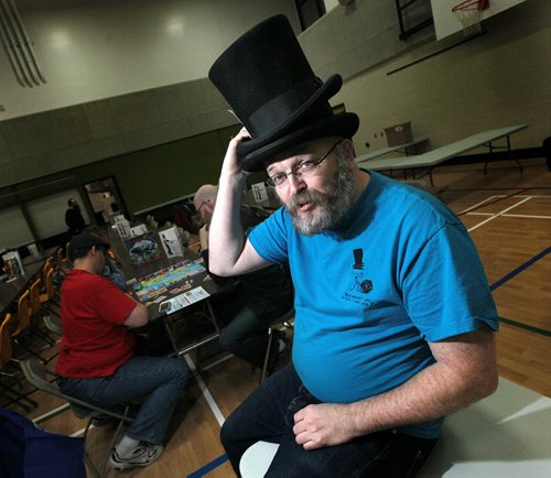 JimCon founder Jim Buchannan tips his trademark top hats at the Bronx Park Community Centre for the fifth annual gamers convention as the doors opened around 530 Friday.. More than 500 individuals are expected to attend JimCon, Winnipegs tabletop games convention, this weekend. Attendees will be playing a variety of board, card, miniature and role-playing games. There are more than 500 board games available for anyone to play  on their own or as part of a scheduled session. There are also tournaments and demonstrations from local game designers. See Randy Turner story. November 13, 2015 - (Phil Hossack / Winnipeg Free Press)