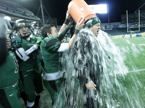 Vincent Massey Trojan Head Coach Kelsey McKay gets the traditional soaking from his team as they defeated St Pauls Crusaders at the Investor's Group Stadium Friday night. See story.....November 13, 2015 - (Phil Hossack / Winnipeg Free Press)