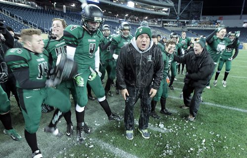 Vincent Massey Trojans celebrate after pouring the traditional water bucket over  Head Coach Kelsey McKay  as they defeated St Pauls Crusaders at the Investor's Group Stadium Friday night. See story.....November 13, 2015 - (Phil Hossack / Winnipeg Free Press)
