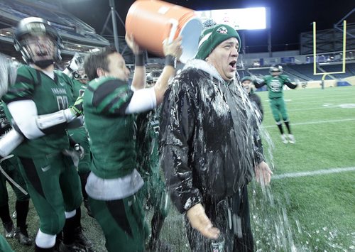 Vincent Massey Trojan Head Coach Kelsey McKay gets the traditional soaking from his team as they defeated St Pauls Crusaders at the Investor's Group Stadium Friday night. See story.....November 13, 2015 - (Phil Hossack / Winnipeg Free Press)