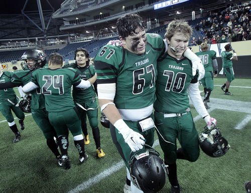 A pair of emotional Vincent Massey Trojans # 67 Keenan Cooke and #70 ??Not on roster?? celebrate on the field afterdefeating the  St Pauls Crusaders at the Investor's Group Stadium Friday night. This is the first championship for the team formed in 2009. See story.....November 13, 2015 - (Phil Hossack / Winnipeg Free Press)