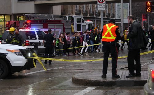 Children attending Manitoba We Day walk by the scene of a pedestrian truck mvc in front of the MTS Centre Monday morning at Portage Ave and Donald-Breaking NewsNov 16, 2015   (JOE BRYKSA / WINNIPEG FREE PRESS)