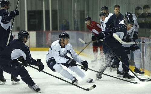 In the centre wearing the white jersey is Manitoba Moose left winger # 5 Thomas Raffl with the puck at the practice in the MTS IcePlex Monday. Ed Tait story  Wayne Glowacki / Winnipeg Free Press Nov. 16   2015