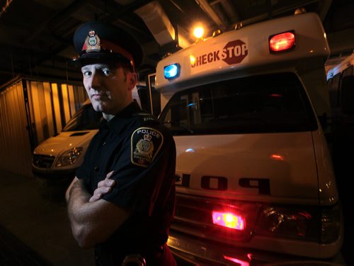 Cst. Stephane Fontaine the WPSs Impaired Driving Counter Measures Coordinator poses in front to the Check Stop Van Monday. He spoke to Gord S. re: Testing for marijuana impairment. See Gord Sinclair story. November 16, 2015 - (Phil Hossack / Winnipeg Free Press)