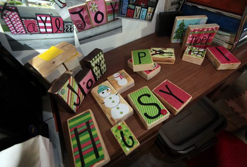 Stacking blocks spell out woords or have colorful charachters.  This is for an Intersection piece on JJaelynne Froese Wormenor biz, "Jbirds & Sonshine". Jaelynne, a mother of three, creates funky home decor out of wooden blocks, which she cuts, sands, paints and decorates herself... Because Santa Claus is coming to town,  See Dave Sanderson story. November 16, 2015 - (Phil Hossack / Winnipeg Free Press)