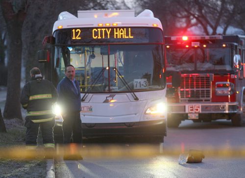 A bus driver stands in front of his bus on Arlington near Adele Ave after it was involved in a mva with a pedestrian near 730 am Wednesday- Fire dept are taping off the scene as hey wait for police to arrive- Breaking NewsNov 18, 2015   (JOE BRYKSA / WINNIPEG FREE PRESS)