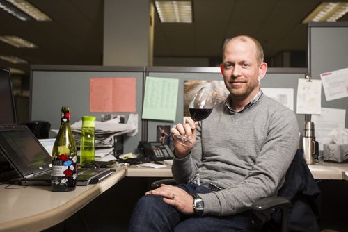 Ben MacPhee-Sigurdson, who has been the Free Press wine columnist for 10 years, tries this year's Beaujolais Nouveau vintage in the newsroom in Winnipeg on Thursday, Nov. 19, 2015.   (Mikaela MacKenzie/Winnipeg Free Press)