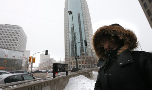 Sheryl Maxwell at a blustery Portage and Main Thursday afternoon heads to the pedestrian underpass to cross Main Street Randy Turner weather story Wayne Glowacki / Winnipeg Free Press Nov. 19   2015