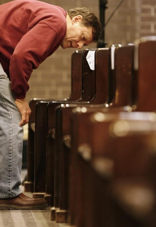 John Woods / Winnipeg Free Press / January 20, 2008 - 080120  - Dr. Glen McCabe checks out the pews that are up for auction at the University of Winnipeg Faculty of Theology auction Sunday January 20, 2008.  All funds will be used for the restoration and upkeep of the new Carl Ridd Sanctuary.