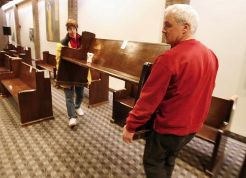 John Woods / Winnipeg Free Press / January 20, 2008 - 080120  - Dennis Swistun (R), of Oak Point Furniture Refinishers and Eric McEwan carry away one of the pews that they bought at the University of Winnipeg Faculty of Theology auction Sunday January 20, 2008.  All funds will be used for the restoration and upkeep of the new Carl Ridd Sanctuary.