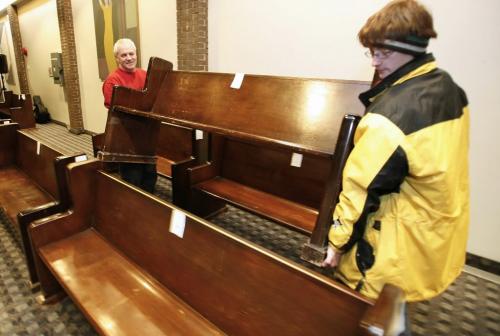 John Woods / Winnipeg Free Press / January 20, 2008 - 080120  - Dennis Swistun (L), of Oak Point Furniture Refinishers and Eric McEwan carry away one of the pews that they bought at the University of Winnipeg Faculty of Theology auction Sunday January 20, 2008.  All funds will be used for the restoration and upkeep of the new Carl Ridd Sanctuary.