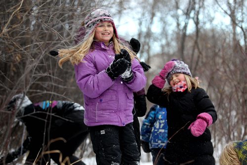 Nine-year-old Adalyn Neufeld (left)  and her little sister Isabel have snow fights with friends and family in the forest along Omands Creek Friday afternoon.   Standup photo Nov 20, 2015 Ruth Bonneville / Winnipeg Free Press