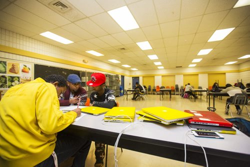 Surafel Kuchem works with newcomer students at the Homework and Education for Youth (HEY) program at Victoria-Albert School in Winnipeg on Friday, Nov. 20, 2015.   (Mikaela MacKenzie/Winnipeg Free Press)