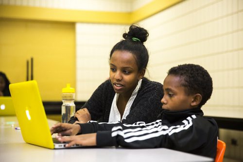 Volunteer Qaalitt Boru helps Yohannes Negasi at the Homework and Education for Youth (HEY) program at Victoria-Albert School in Winnipeg on Friday, Nov. 20, 2015.   (Mikaela MacKenzie/Winnipeg Free Press)