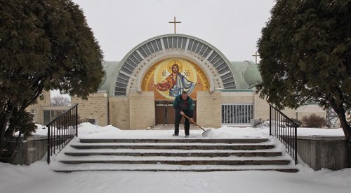 Peter Skrinski, a parishioner at St. Nicholas Ukrainian Catholic Church on Arlington Avenue shovels the walk before mass Sunday.  151122 November 19, 2015 MIKE DEAL / WINNIPEG FREE PRESS