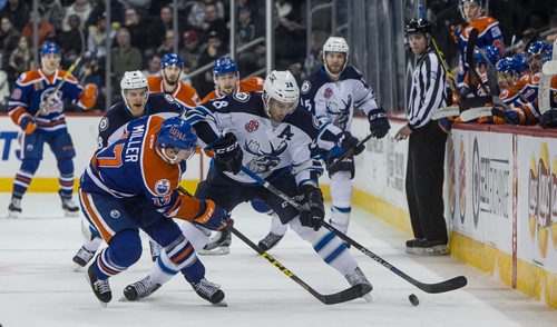 Manitoba Moose' Patrice Cormier (28) checks Bakersfield Condors' Andrew Miller (17) during first period AHL action at MTS Centre Sunday afternoon. 151122 - Sunday, November 22, 2015 -  MIKE DEAL / WINNIPEG FREE PRESS