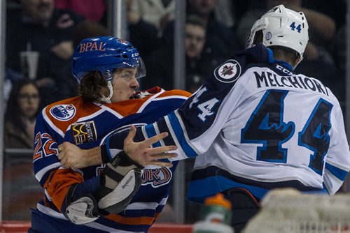 Manitoba Moose' Julian Melchiori (44) trades punches with Bakersfield Condors' Kale Kessy (22) during first period AHL action at MTS Centre Sunday afternoon. 151122 - Sunday, November 22, 2015 -  MIKE DEAL / WINNIPEG FREE PRESS