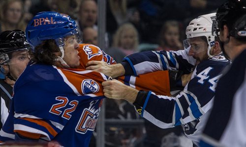 Manitoba Moose' Julian Melchiori (44) trades punches with Bakersfield Condors' Kale Kessy (22) during first period AHL action at MTS Centre Sunday afternoon. 151122 - Sunday, November 22, 2015 -  MIKE DEAL / WINNIPEG FREE PRESS