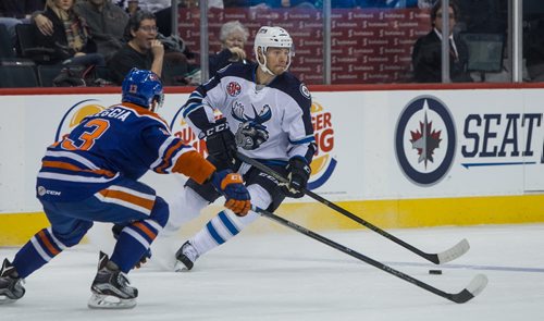 Manitoba Moose' Thomas Raffl (5) looks to pass the puck past Bakersfield Condors' Joey LaLeggia (13) during second period AHL action at MTS Centre Sunday afternoon. 151122 - Sunday, November 22, 2015 -  MIKE DEAL / WINNIPEG FREE PRESS