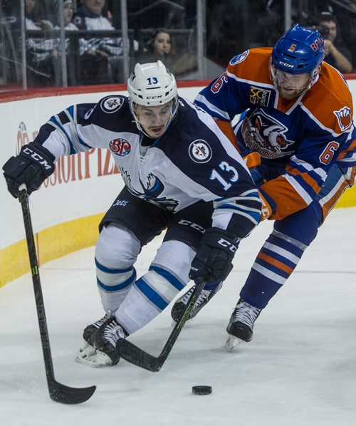 Manitoba Moose' Nic Petan (13) keeps control of the puck while behind the net despite being hounded by Bakersfield Condors' David Musil (6) during second period AHL action at MTS Centre Sunday afternoon. 151122 - Sunday, November 22, 2015 -  MIKE DEAL / WINNIPEG FREE PRESS
