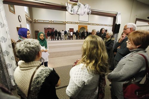 November 22, 2015 - 151122  -  Attendees look on as men pray during an open house at Winnipeg's Grand Mosque Sunday, November 22, 2015.  John Woods / Winnipeg Free Press