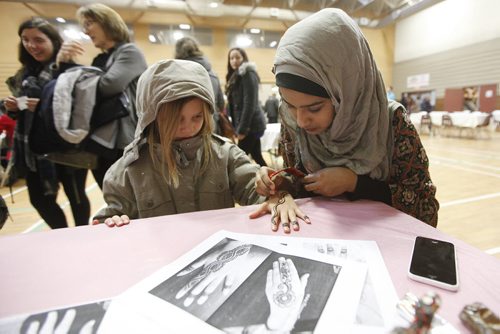November 22, 2015 - 151122  -  Ayesha Anwar applies henna to a girl during an open house at Winnipeg's Grand Mosque Sunday, November 22, 2015.  John Woods / Winnipeg Free Press