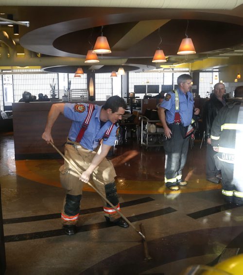 Winnipeg Fire Fighters clean up water on the floor in the Grace Cafe in the court yard of City Hall Monday morning. Wayne Glowacki / Winnipeg Free Press Nov. 23   2015