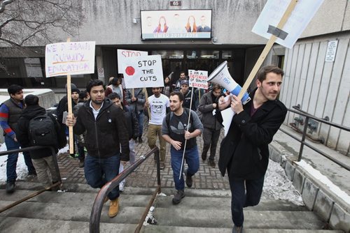 Matthew Brett (right), campaign organizer CFS-Manitoba, helps lead International students, students and faculty in a 'Stop the Cuts' rally before a board of governors meeting at the University of Manitoba.   November 24, 2015 Mike Deal / Winnipeg Free Press