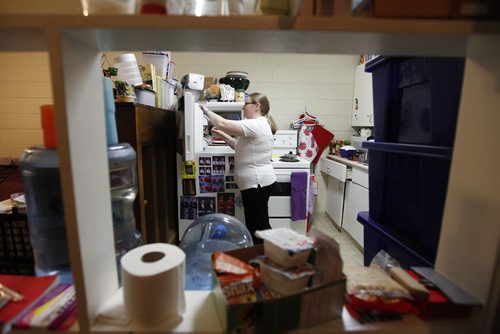 November 23, 2015 - 151123  -  Shelley Sauve, who works several jobs to stay afloat, is photographed in the kitchen of her apartment with her two sons Miquel (13) and Gary (19) Tuesday, November 23, 2015. Save is a special education teacher struggling to make ends meet on several part-time jobs. John Woods / Winnipeg Free Press