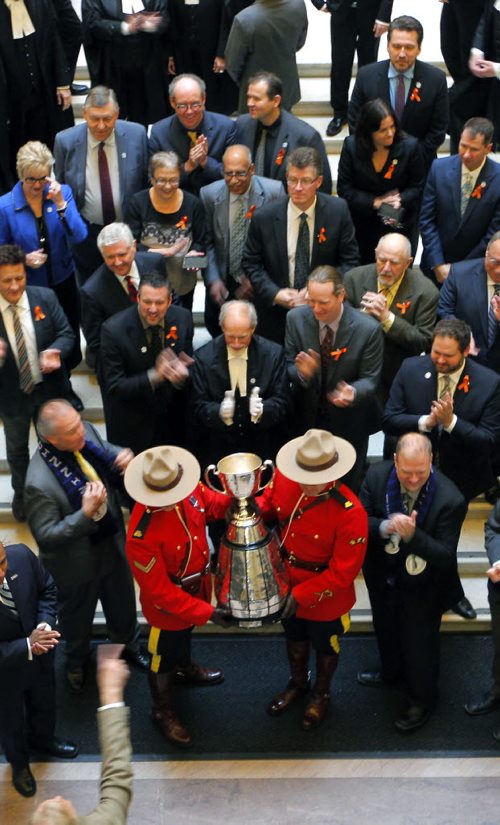 The CFL Grey Cup arrives at the Manitoba Legislature. It was marched into the chambers and then out for a group shot on the steps inside. BORIS MINKEVICH / WINNIPEG FREE PRESS  NOV 25, 2015