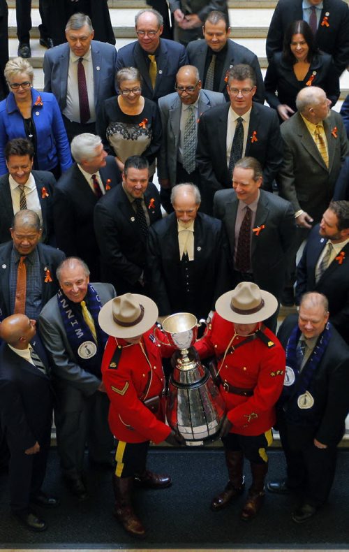 The CFL Grey Cup arrives at the Manitoba Legislature. It was marched into the chambers and then out for a group shot on the steps inside. BORIS MINKEVICH / WINNIPEG FREE PRESS  NOV 25, 2015