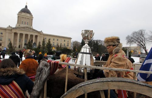 Brayden Anderson carries the Grey Cup to the Manitoba Legislative Building on a Red River Cart for the kickoff to Grey Cup festivities in Winnipeg, Man.. BORIS MINKEVICH / WINNIPEG FREE PRESS  NOV 25, 2015