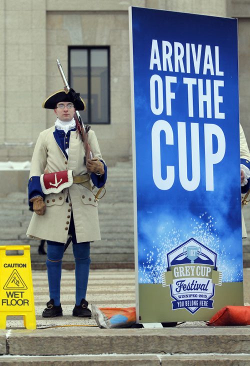 The CFL Grey Cup arrives at the Manitoba Legislature by Red River Cart. Metis , RCMP, and Aboriginal paraded the cup to the Leg in an official event. In the background some period correct actors stand silently and watch the event.  BORIS MINKEVICH / WINNIPEG FREE PRESS  NOV 25, 2015
