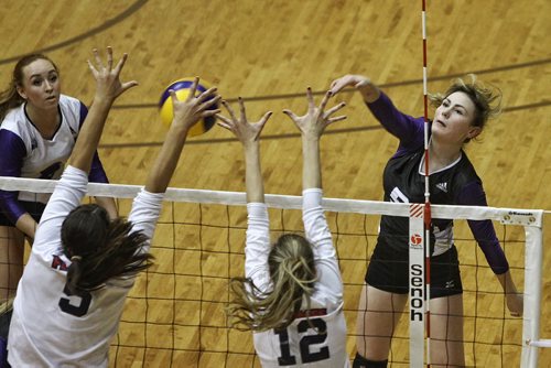 Brandon's Vincent Massey Vikings' Madison Beaubier (5) tries to spike the ball over defenders St. Mary's Academy Flames' Kearley Abbott (5) and Darby Coughlin (12) during AAAA provincial varsity girls volleyball semifinals at Investors Group Gym at the University of Manitoba Wednesday evening.    151125 November 25, 2015 MIKE DEAL / WINNIPEG FREE PRESS