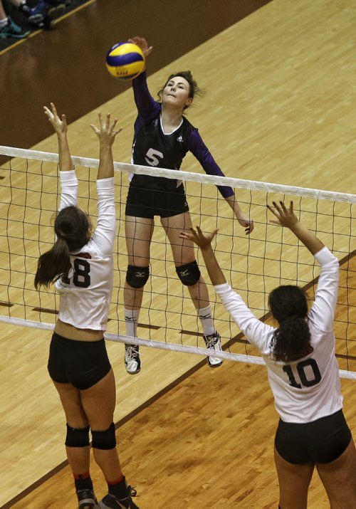 Brandon's Vincent Massey Vikings' Madison Beaubier (5) tries to spike the ball over defenders St. Mary's Academy Flames' Jenna Cross (18) and Laura Hill (10) during AAAA provincial varsity girls volleyball semifinals at Investors Group Gym at the University of Manitoba Wednesday evening.    151125 November 25, 2015 MIKE DEAL / WINNIPEG FREE PRESS