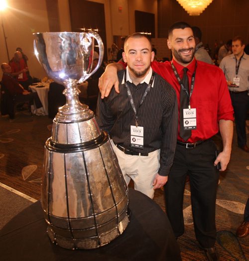 Ottawa Redblacks players -l to R- John Boyettand and Ettore Lattanzio pose with Grey Cup at Grey Cup East Division Champions Media Breakfast at the Delta Hotel in downtown Winnipeg -See storyNov 26, 2015   (JOE BRYKSA / WINNIPEG FREE PRESS)