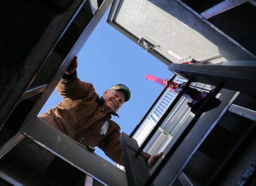 Guy Ash about to climb back down an access hatch after checking on one of his weather stations at Investors Group Field prior to Sundays Grey Cup, Thursday, November 26, 2015. (TREVOR HAGAN/WINNIPEG FREE PRESS)