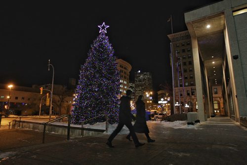 Mayor Brian Bowman walks past the huge tree that was just lit up at City Hall Thursday evening.  151126 November 26, 2015 MIKE DEAL / WINNIPEG FREE PRESS