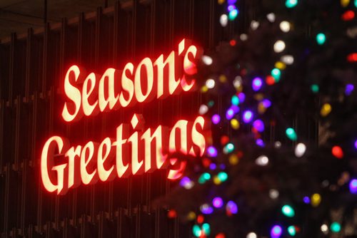 A season's greetings sign on the side of City Hall glows bright along with the holiday lights that were lit up on the huge tree at City Hall Thursday evening.  151126 November 26, 2015 MIKE DEAL / WINNIPEG FREE PRESS