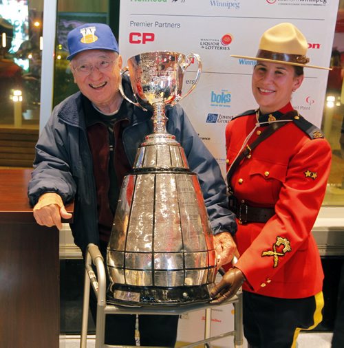 CFL AWARDS RED CARPET EVENT AT CLUB REGENT - Fans and players get to mingle.  Big CFL fan Nick Baraniuk poses with the Grey Cup . Mounty did not want name used. BORIS MINKEVICH / WINNIPEG FREE PRESS  NOV 26, 2015