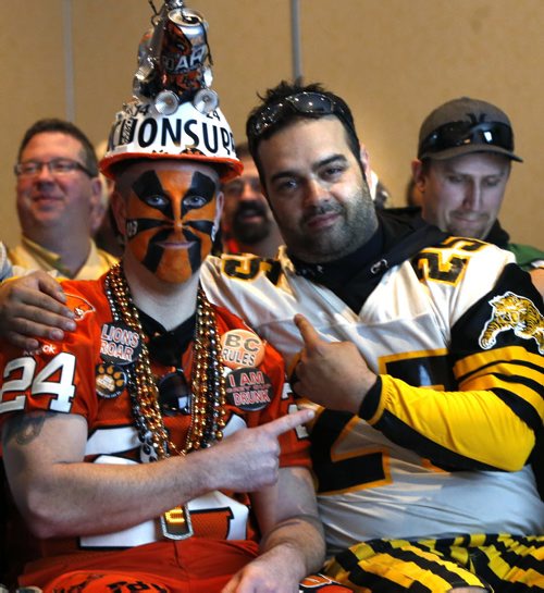 At left, BC Lions fan Kyle Dunn and Tiger-Cat fan Jason Mondoux came to hear CFL Commissioner Jeffrey L. Orridge speak about  State of the League. The room was full of fans attending the event at the Fairmont Winnipeg Friday and had a chance to have their picture taken with the Grey Cup. Wayne Glowacki / Winnipeg Free Press Nov. 27    2015