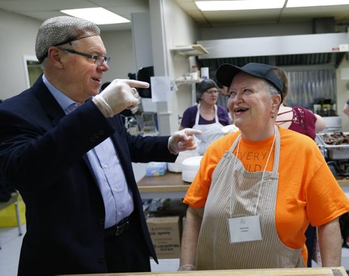 Premier Greg Selinger wishes he got a ball cap like Pat Kobylak to wear while working with the volunteers handing out pancake breakfasts at the Indian and Metis Friendship Centre for Lite's 19th Annual Wild Blueberry Pancake Breakfast Friday morning. He soon switched to a toque. The event helps fund employment opportunities for people breaking out of poverty in our inner city. There was entertainment and ¤many craft tables set up.¤Wayne Glowacki / Winnipeg Free Press Nov. 27    2015