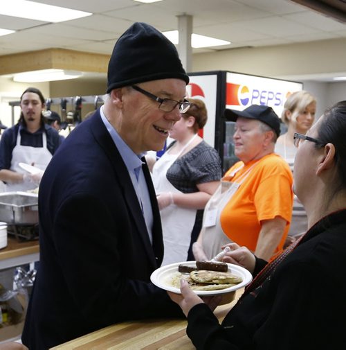 Premier Greg Selinger helps out with volunteers handing out pancake breakfasts at the Indian and Metis Friendship Centre for Lite's 19th Annual Wild Blueberry Pancake¤Breakfast Friday morning. The event helps fund employment opportunities for people breaking out of poverty in our inner city. ¤There was entertainment and many craft tables set up.  Wayne Glowacki / Winnipeg Free Press Nov. 27    2015