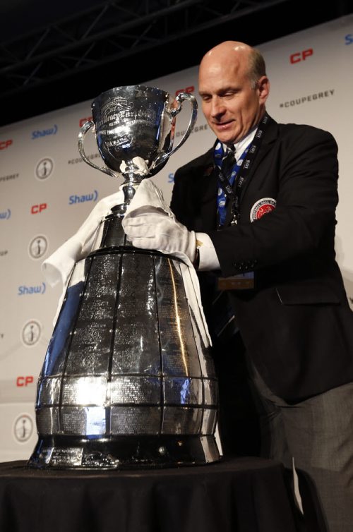 Jeff McWhinney polishes up the Grey Cup for CFL Commissioner Jeffrey L. Orridges first annual State of the League Media Conference on Friday.  Wayne Glowacki / Winnipeg Free Press Nov. 27    2015