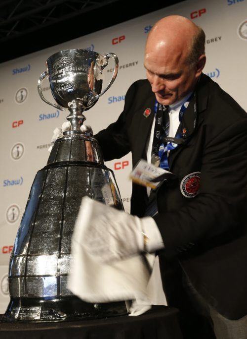 Jeff McWhinney polishes up the Grey Cup for CFL Commissioner Jeffrey L. Orridges first annual State of the League Media Conference on Friday.  Wayne Glowacki / Winnipeg Free Press Nov. 27    2015