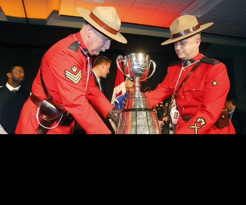 CFL ALUMNI LUNCH AND HALL OF FAME - The Grey Cup gets brought in to the event by un named RCMP officers. BORIS MINKEVICH / WINNIPEG FREE PRESS  NOV 27, 2015
