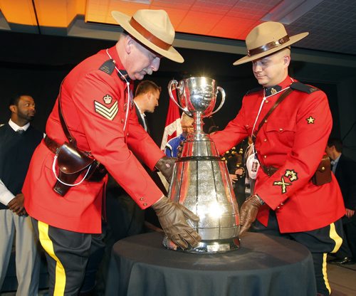 CFL ALUMNI LUNCH AND HALL OF FAME - The Grey Cup gets brought in to the event by un named RCMP officers. BORIS MINKEVICH / WINNIPEG FREE PRESS  NOV 27, 2015